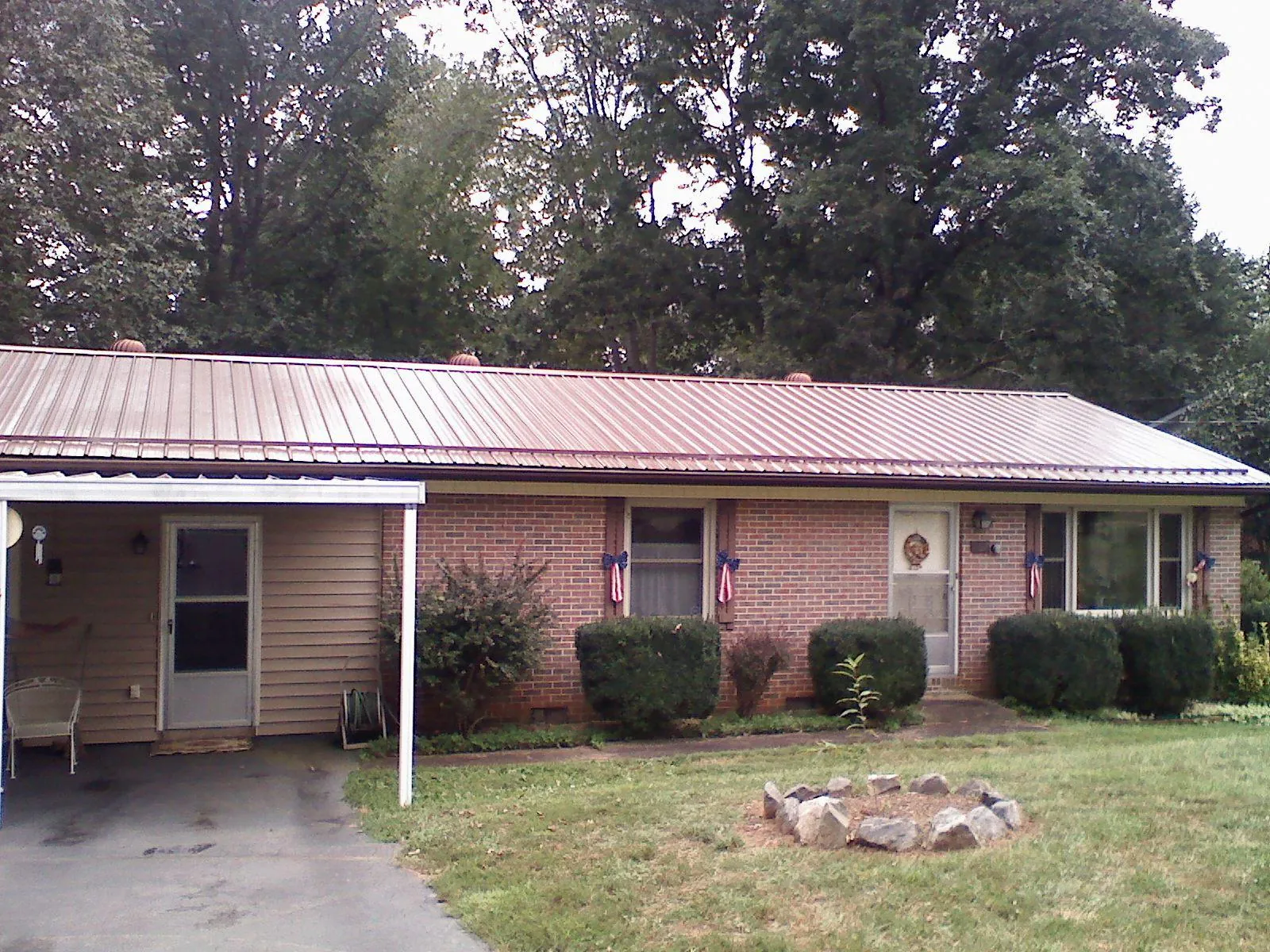 Bronze metal roof and carport on a brick ranch home — Roof Repair work by our crew in West Roxbury